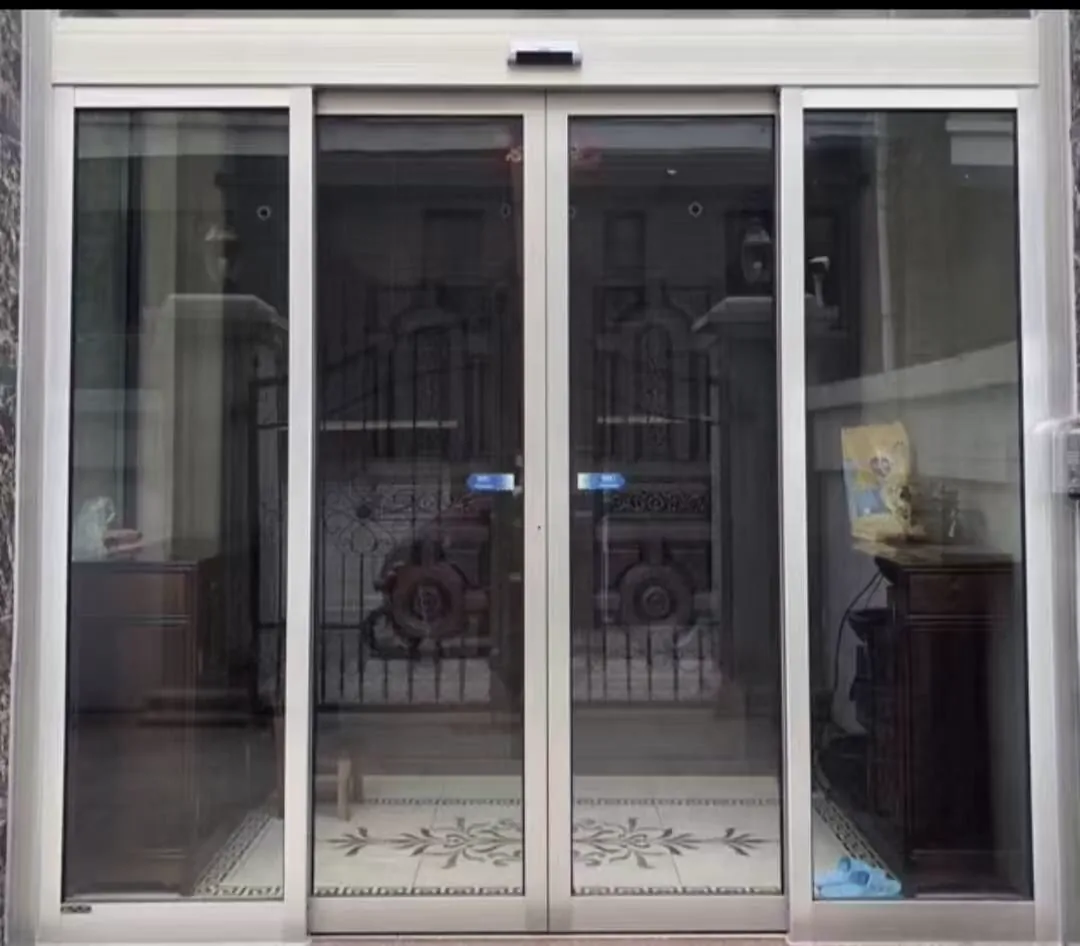 Residential automatic entrance with white metal framing